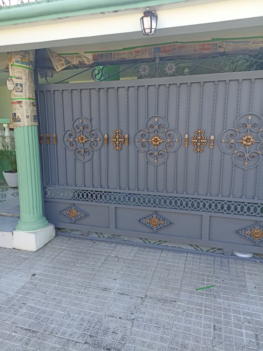 Portón ornamental con acentos dorados — Tayer El Buen Pastor, Santo Domingo